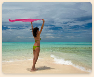 Beautiful woman in a bikini on the beach in Los Roques, Venezuela.
