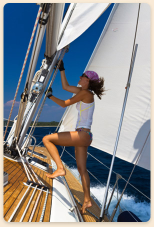 Woman on a sailboat rental off Gran Roque island, Los Roques, Venezuela.